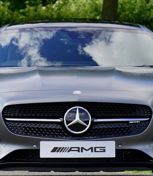 Front view of a luxury Mercedes-Benz AMG against a natural backdrop.